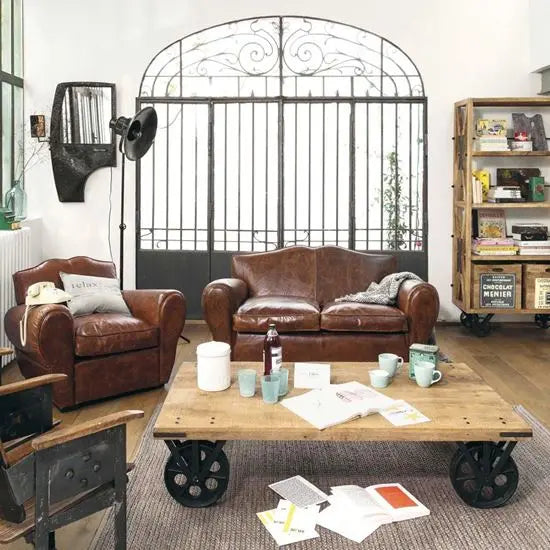 Rectangular samveiga veelo coffee table with a distressed mango wood top and metal movable wheels.