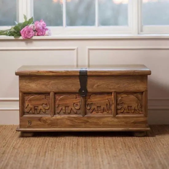 A solid wooden storage box with an elephant carving on the front, featuring a vintage style lock and a dark brown finish.