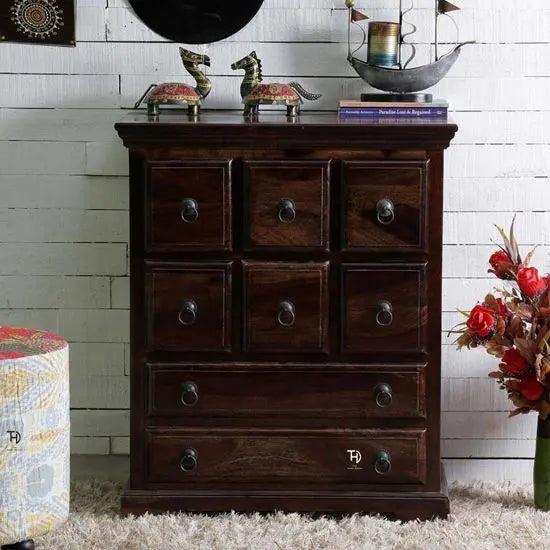 A vintage chest of drawers made of Sheesham wood, with eight drawers and metal handles.