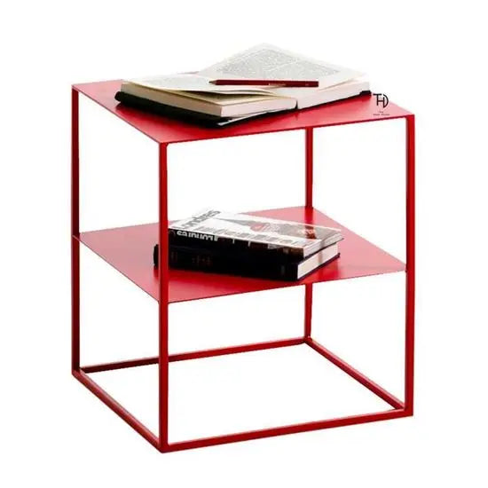 A red metal end table with two shelves, one on top of the other one in middle.