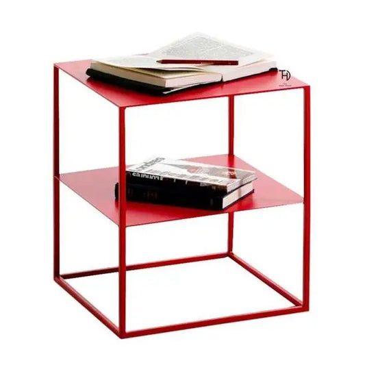 A red metal end table with two shelves, one on top of the other one in middle.