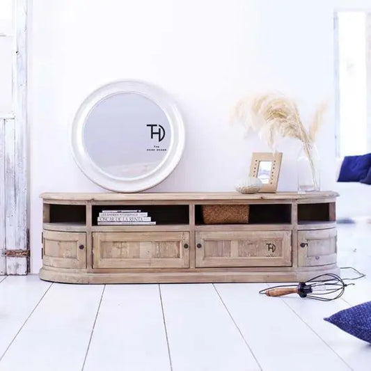 A brown, half-round shaped TV cabinet with four doors, made of solid wood, displayed in a room setting with decorative items on top.