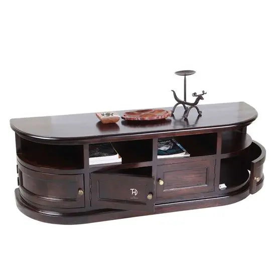 A brown, half-round shaped TV cabinet with four doors and a shelf, made of wood, with metal handles and a decorative item on top.