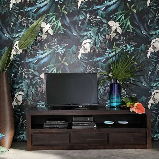 A dark brown DarKeen TV Cabinet with three drawers and one open shelf, placed against a wall with floral wallpaper. A flat-screen TV is placed on top of the cabinet, and there are decorative items on the shelves.