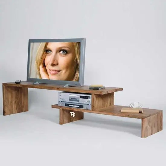 A wooden TV cabinet with open shelves, displaying a television and some electronic devices on it.