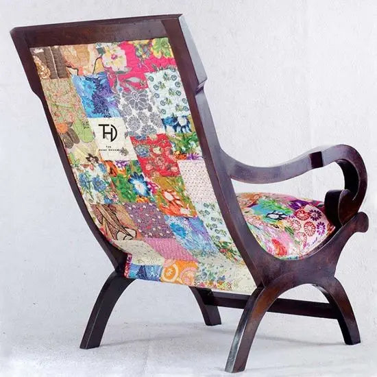 Relax Chair with a walnut stained sheesham wood structure and multicolored patchwork fabric upholstery.