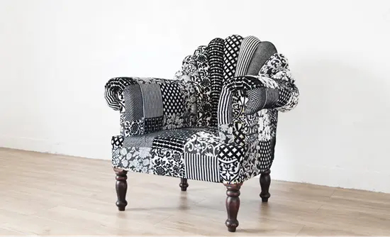 A black and white upholstered Peacock sofa in patchwork.