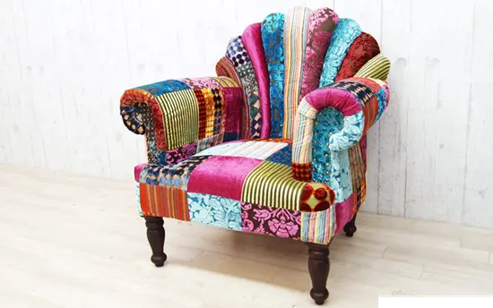 showcasing a variety of fabric patterns and colors. Assorted patchwork sofa.