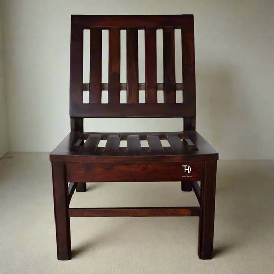 A brown Amira Low Chair with a slatted back and seat, made of solid wood in a walnut finish.