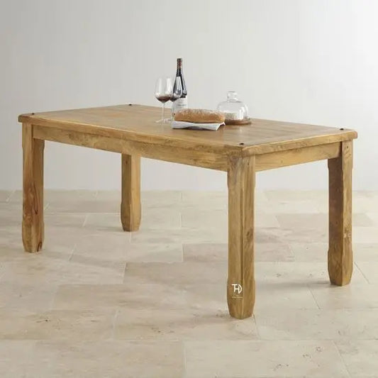 A mango wood 4 seater dining table with a  wooden table top.