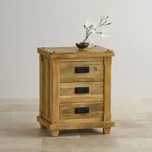 A wooden bedside table with three drawers and a side cabinet, featuring metal handles.