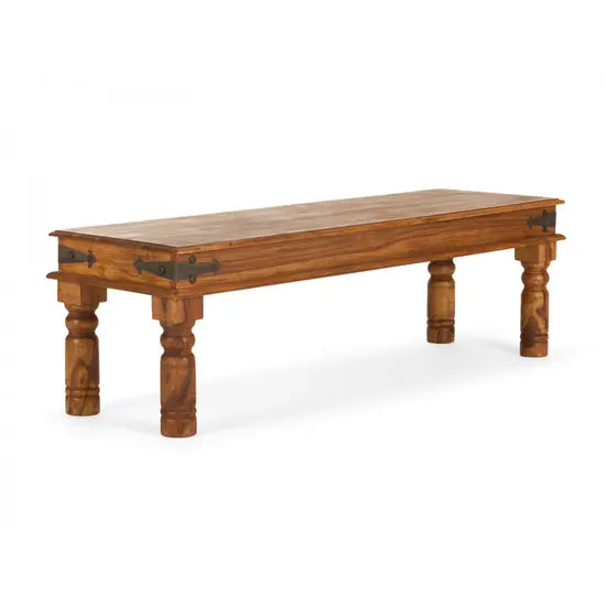 A wooden dining bench with a rectangular tabletop and ornate detailing on the legs.