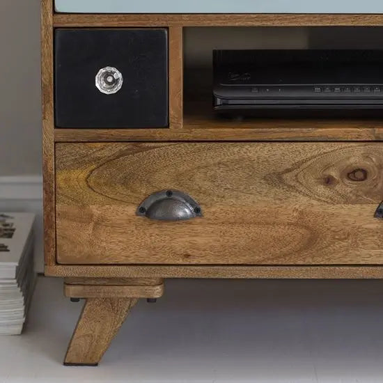 A detail shot of a multicolor TV cabinet made of solid mango wood.