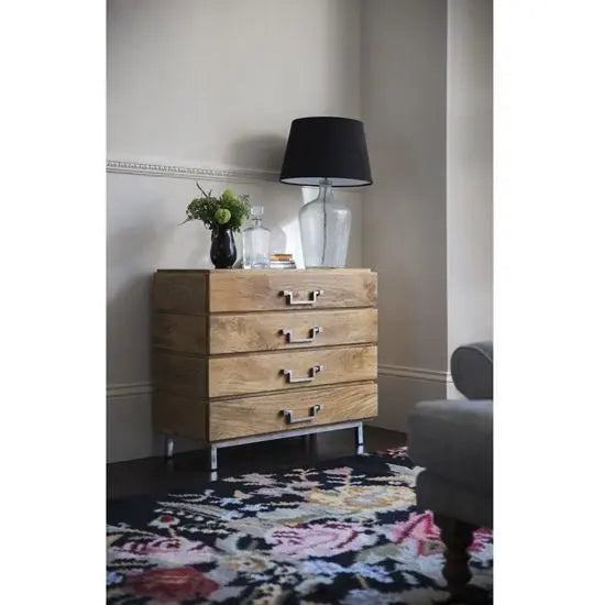 A wooden chest of 4 drawers with a stainless steel base.