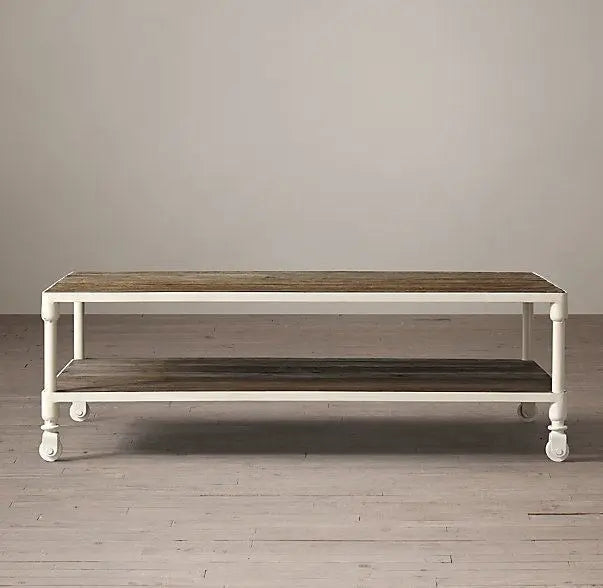 Wooden coffee table with white metal frame and wheels.