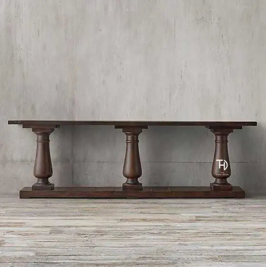 A rectangular console table made of Sheesham wood with a mahogany finish, featuring three turned legs.