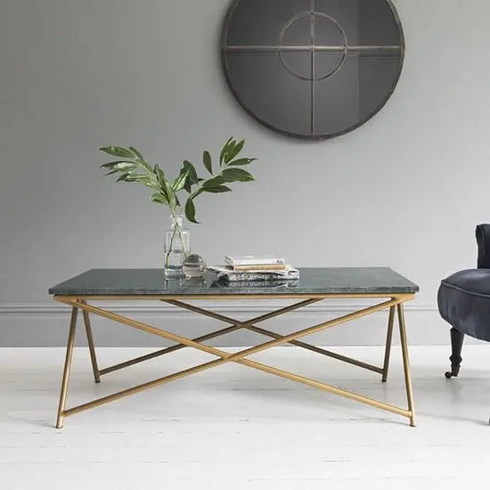 A sleek rectangle-shaped coffee table with a Banswara green marble top and a metal frame.