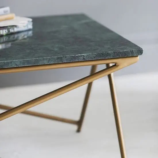 A sleek rectangle-shaped marbi cyna coffee table with a Banswara green marble top and a gold coated metal frame.