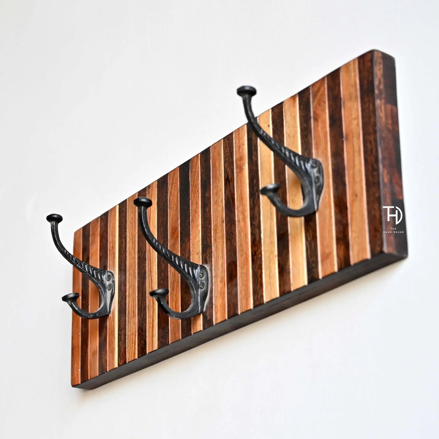 Solid acacia wood wall hook with black metal hooks.
