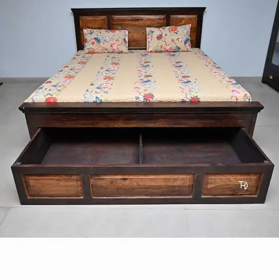 A king size bed with a wooden frame and storage drawers beneath, showcasing a plain yet sturdy design.