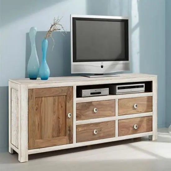 A white Penguin TV cabinet made of solid sheesham wood with one door, four drawers, and an open shelf, with a flat-screen TV on top.