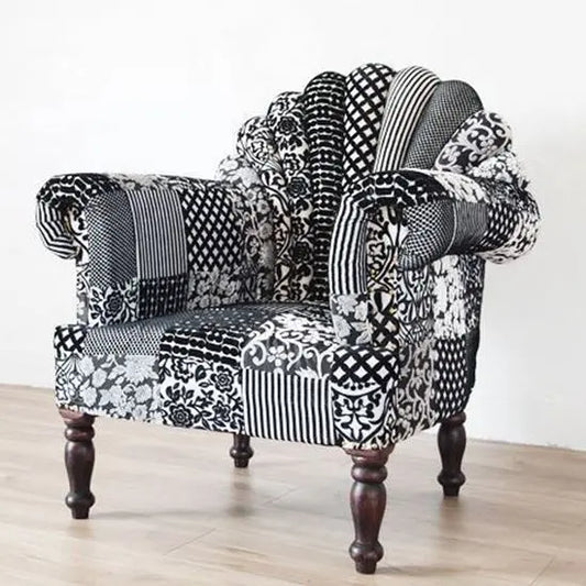 A black and white upholstered Peacock sofa with a vibrant pattern, hand-made on solid Sheesham wood with a walnut finish.