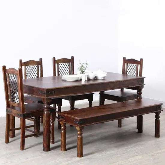 A vintage dining set made of Sheesham wood, including a rectangular dining table, four chairs, and a two-seater bench.