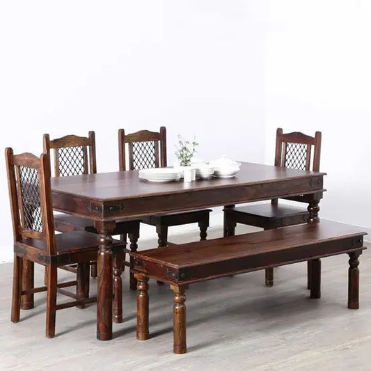 A vintage dining set made of Sheesham wood, including a rectangular dining table, four chairs, and a two-seater bench.