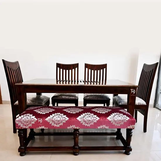 A six-seater dining set with a rectangular table, four chairs, and a bench with a patterned fabric on the bench's seat cushion.