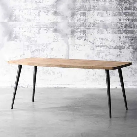 A rectangular dining table with black wooden legs and a natural mango wood finish top. Simple and strong dining table.