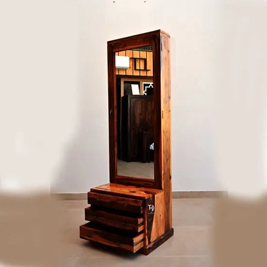 A wooden dressing table with a large mirror, multiple drawers, and a shutter on the side.