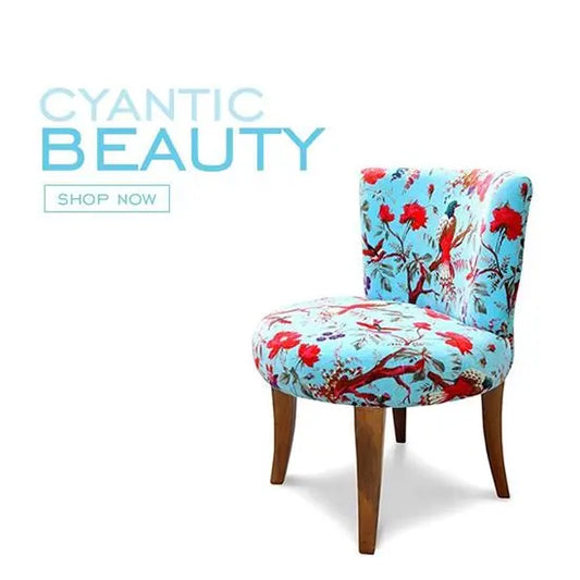 A blue and red floral velvet-upholstered chair with sheesham wood legs.