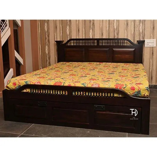 A traditional design Amaanat Storage Bed made of Sheesham wood with a warm walnut finish, featuring a floral patterned bedsheet and storage drawers at the foot.