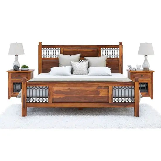 A vintage wooden bed frame with a headboard and footboard, accompanied by nightstands with lamps on either side.