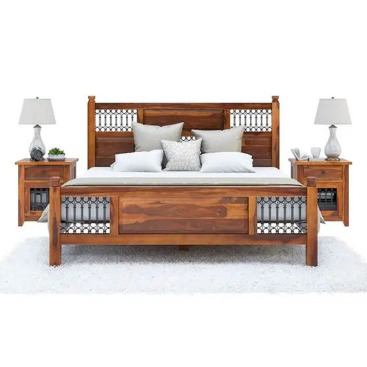 A vintage wooden bed frame with a headboard and footboard, accompanied by nightstands with lamps on either side.