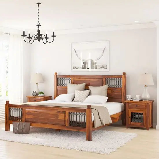 A vintage wooden bed frame with a headboard and footboard with metal work.