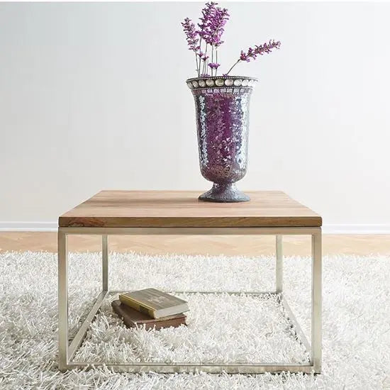 A small square coffee table made of Sheesham wood with a stainless steel base.