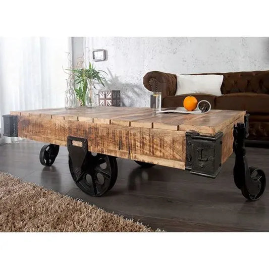 An industrial style Kart Coffee Table with distressed finish, featuring cast iron corners and wheels, mango wood top, and metal accents.