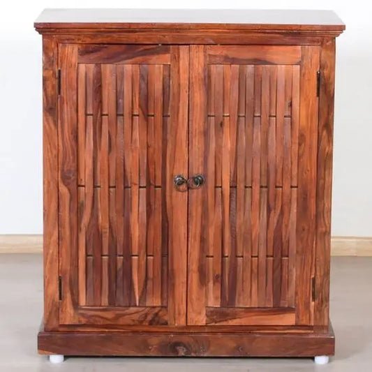 A wooden Latin shoe rack with closed doors, made from solid Sheesham wood with metal handles, intended for indoor use.
