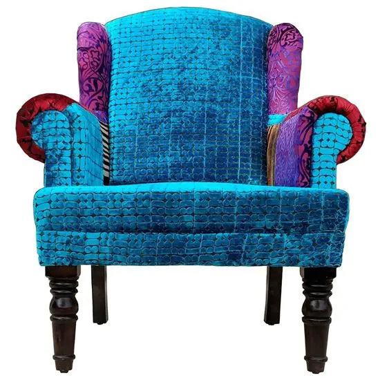 A blue Maharaja sofa with velvet upholstery and wooden legs online.