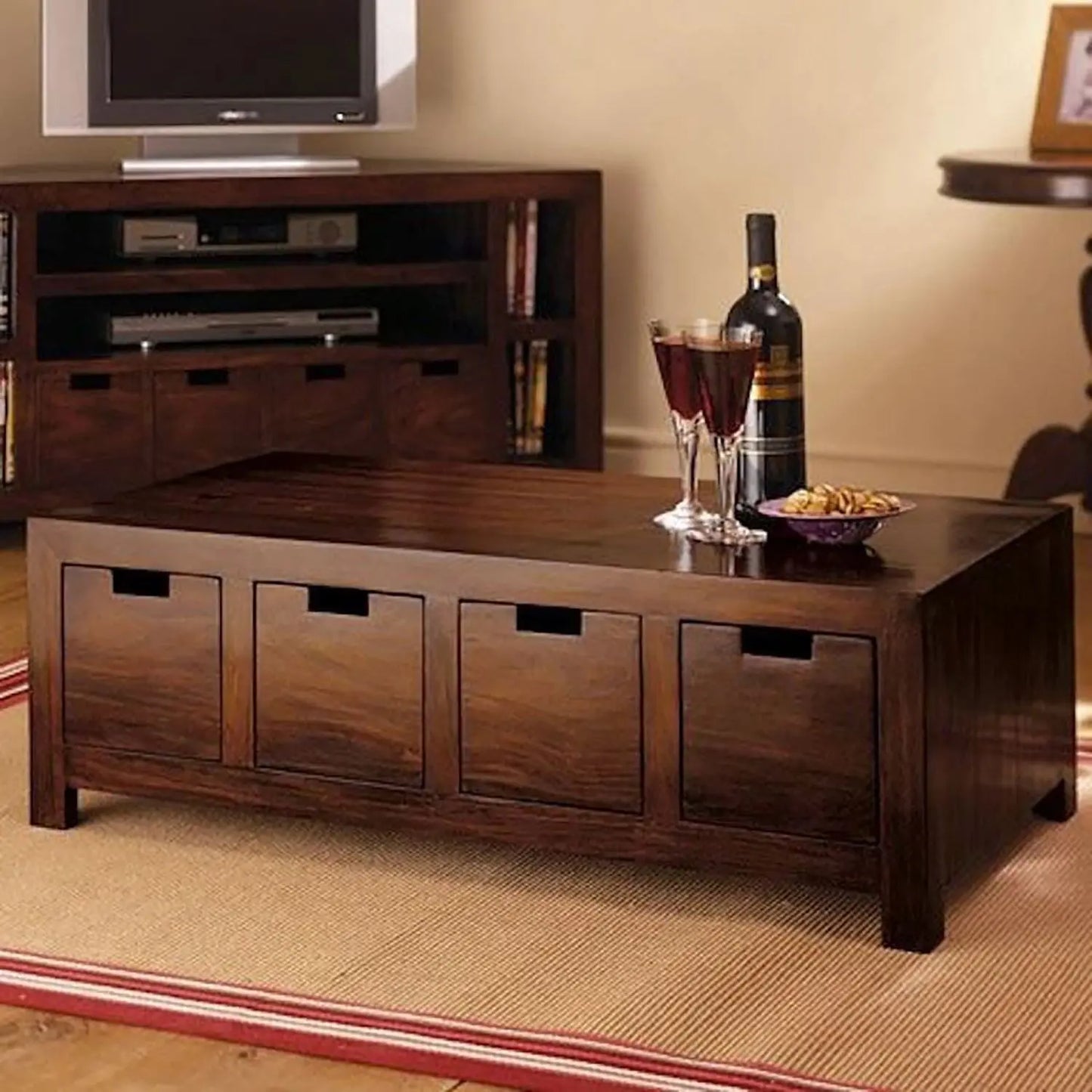 Solid wood coffee table with storage drawers in a living room setting.