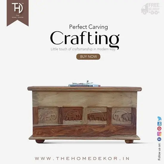 A solid Sheesham wood storage trunk with elephant carvings and a vintage style lock.