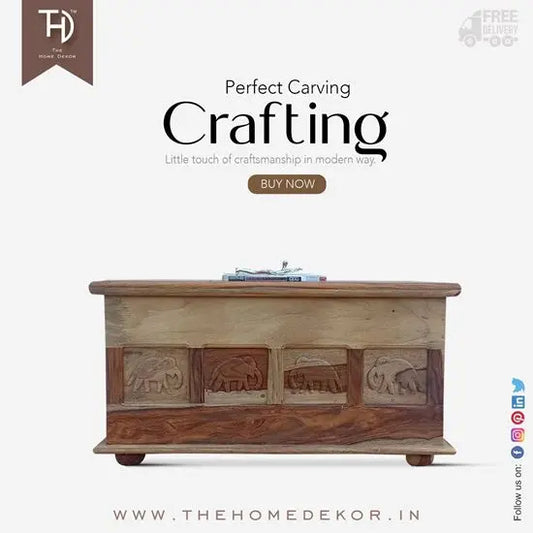 A solid Sheesham wood storage trunk with elephant carvings and a vintage style lock.