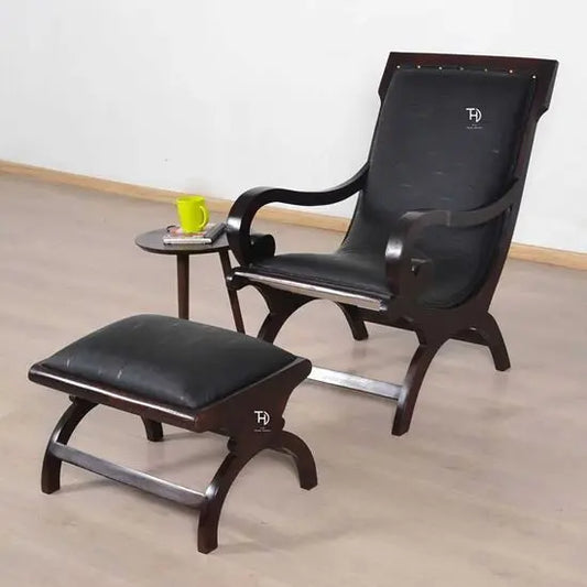 A black artificial leather upholstered Rambo Relax chair with walnut finish and an ottoman.