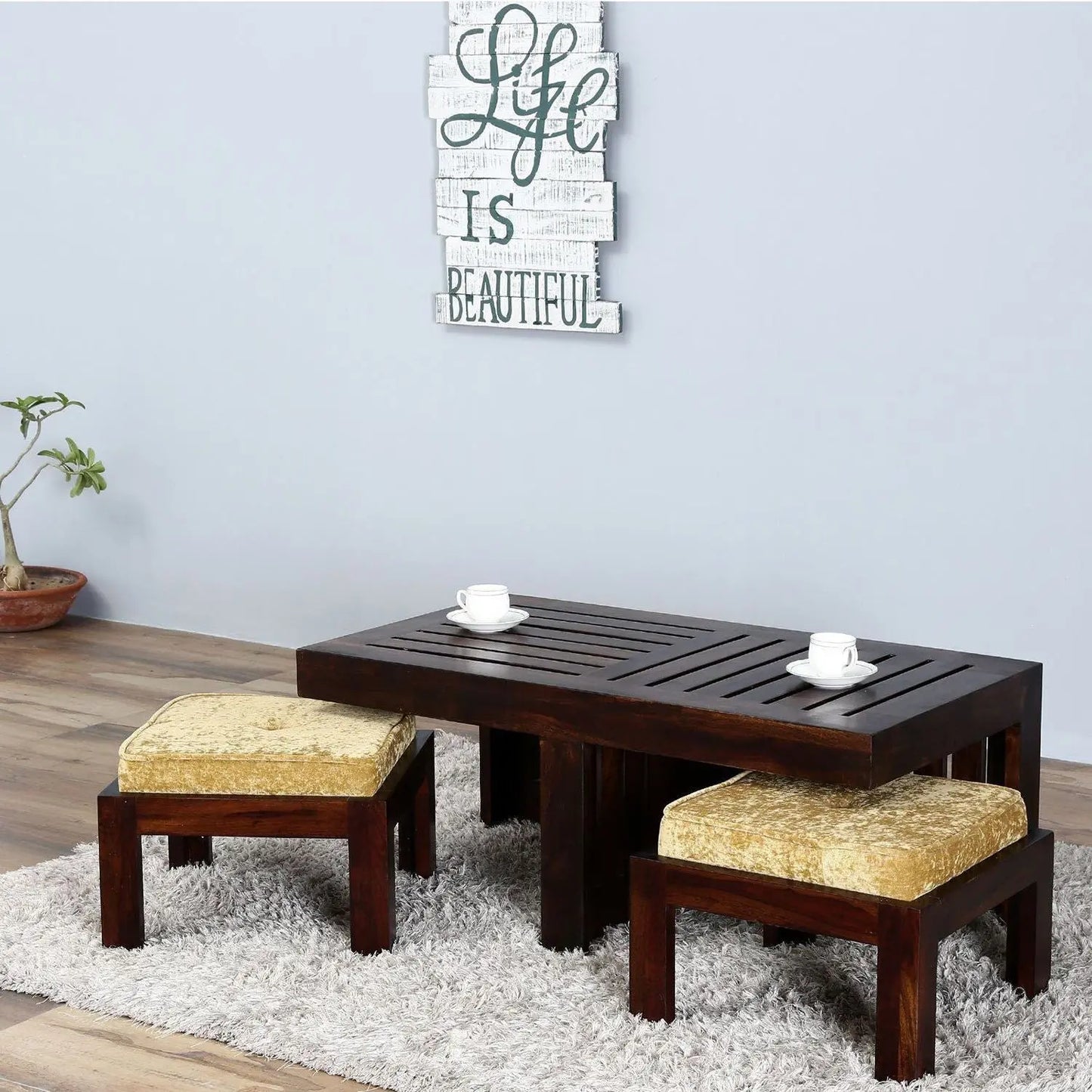 Solid wood Rectangle shilbyra coffee table with two cushioned stools.