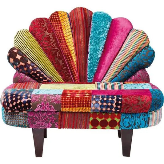 A colorful, patchwork fabric covered Peacock Sofa with a unique peacock wing styled backrest.