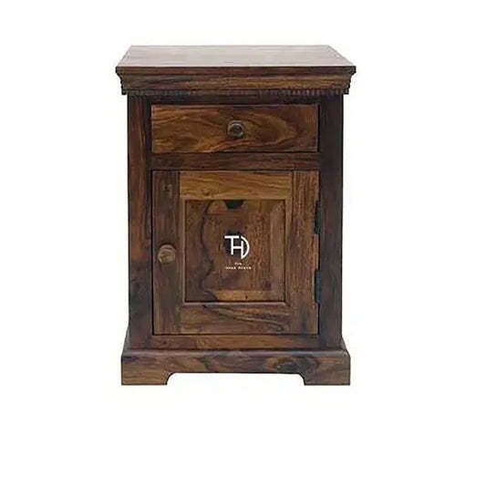 A brown Sheesham wood vintage bedside table with one drawer and one door, featuring simplistic design.