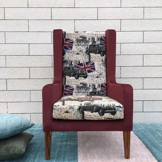 A red upholstered wing chair, featuring a floral and geometric pattern with england flag print.