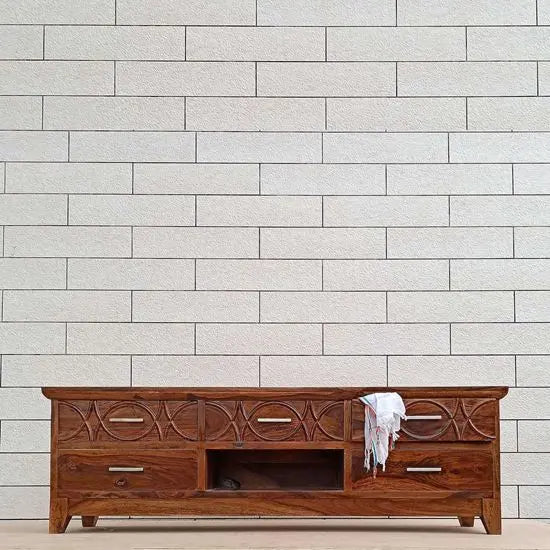 A brown Sheesham wood rope-tv cabinet with five drawers, featuring intricate rope designs on the front.