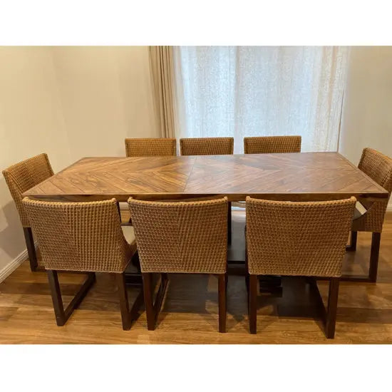 It is a eight seater dining table made up of acacia wood.